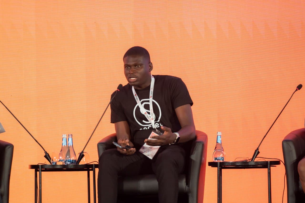 Kayode Popoola speaking on a conference panel.